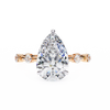 Rose Gold Pear Cut Diamond Ring with Hidden Halo and Spaced Round Eternity Band